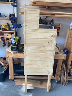 a wooden cabinet sitting on top of a workbench