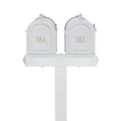 two white mailboxes with numbers on them