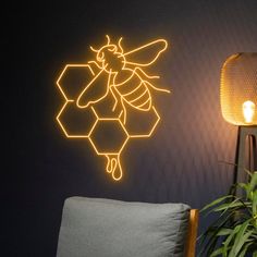 a yellow neon bee sitting on top of a wall next to a chair and lamp