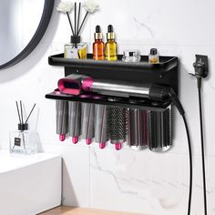 a hair dryer and combs on a shelf in a bathroom