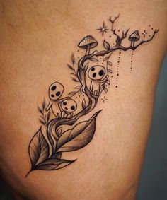 an artistic tattoo design on the side of a woman's thigh with skulls and leaves