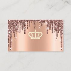 a rose gold glitter business card with a crown on it