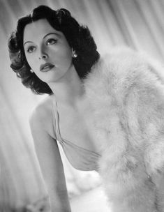 a black and white photo of a woman with fur