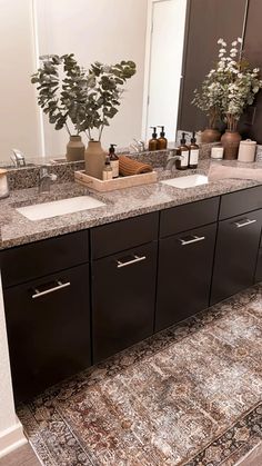 a bathroom with two sinks and a rug on the floor