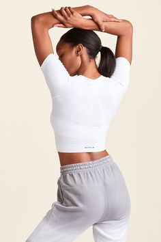 Full back view of Alala Women's Luxury Athleisure white seamless cropped tee Bra Size Charts, Workout Crop Top, Seamless Bra, White Tee, Everyday Wardrobe, Crop Tee, Fashion Tees, Bra Sizes, White Shorts