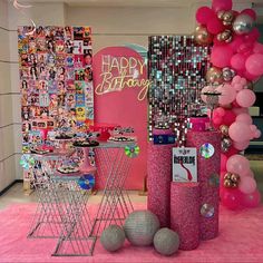 a pink birthday party with balloons and decorations