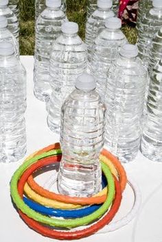 a bunch of water bottles sitting on top of a table with rubber bands around them