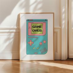 a framed game over poster sitting on the floor in front of a wall with an open door