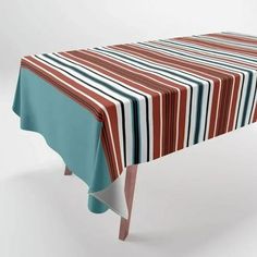 a striped table cloth on top of a wooden table