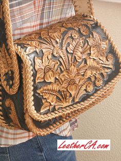 a close up of a person holding a purse with flowers on the front and sides