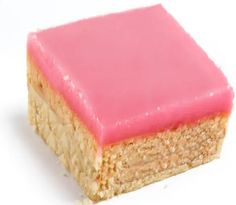 a square piece of cake with pink frosting on it's top and bottom