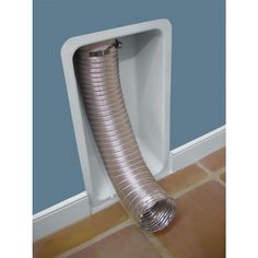 a large metal pipe sticking out of the side of a wall next to a tile floor