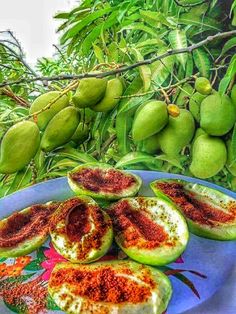 the fruit is cut up and ready to be eaten on the plate with other fruits in the background