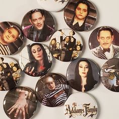 the addams family buttons are arranged on a white surface with black and white images