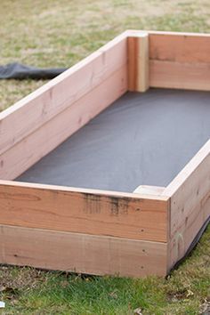 an empty wooden box sitting in the grass