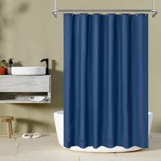 a blue shower curtain in a bathroom