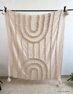 a white wall hanging on a clothes line