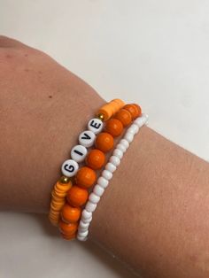 Orange and white bracelet stack that includes three bracelets. Each are made with extra stretch string to fit mostly all sizes. They are great to style with a fall outfit! Or, to a Thanksgiving event. If you have any questions please message me. Thanksgiving Bracelet Ideas, Angel Halos, Fall Bracelet Ideas, Fall Bracelets, Angel Halo, Autumn Bracelet, Bracelet Inspo, Bracelets Patterns, White Bracelet