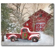 an old red truck with a christmas tree in the bed is parked next to a barn