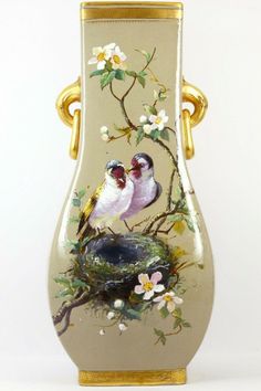 a vase with two birds painted on it