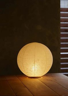 a white lamp sitting on top of a wooden table