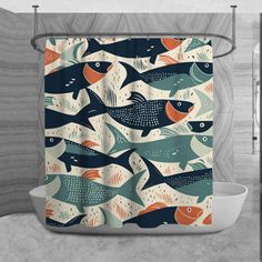 a bathroom with a shower curtain that has fish on it and is decorated in blue, orange