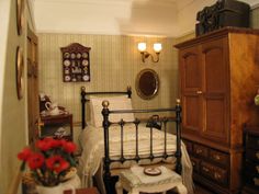 a bed room with a neatly made bed next to a wooden dresser and mirror on the wall