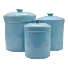 three blue canisters with lids on white background