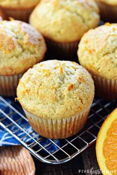 orange muffins cooling on a wire rack