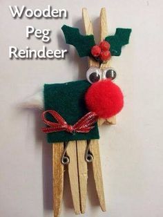 a wooden peg reindeer with red nose and antlers on it's head is hanging from a wall