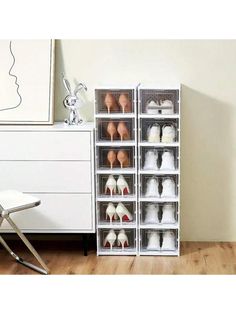 a white chair sitting next to a stacking unit filled with shoes