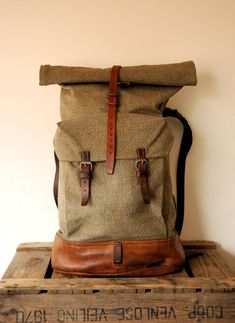 Swiss Army Backpack - Roll Top - from 1950s, made from canvas and leather.   In very good vintage < < < P R O D U C T  D E S C R I P T I O N > > > Perhaps the best military canvas rucksack of all time and certainly the most sought-after, this is the 1950's canvas and leather Swiss Army Backpack . The design was so successful it remained in use for decades even being re-made using a ballistic nylon material as seen in the Swiss Backpack from the 1980's. The Swiss Army Backpack has tough forged an Vintage Backpack With Leather Backing, Retro Canvas Backpack For Travel, Retro Leather Backpack, Vintage Standard Backpack For Everyday, Vintage Leather Backpack For School, Vintage Rectangular Leather Backpack, Vintage Style Everyday Backpack, Everyday Vintage Leather Backpack, Everyday Vintage Satchel Backpack