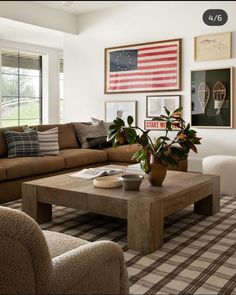 a living room filled with furniture and pictures on the wall