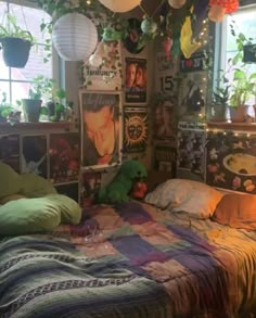 a bed room with a neatly made bed and lots of plants hanging from the ceiling