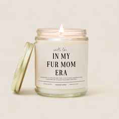 a candle with the words in my fur mom era on it