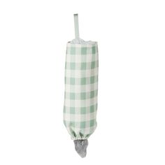 a green and white checkered umbrella hanging from a hook on a pole with an attached handle