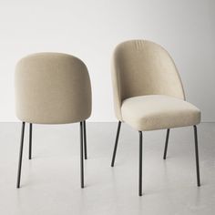 two chairs sitting side by side on top of a white floor next to each other