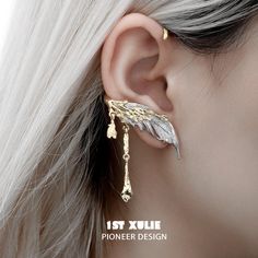 Wings of Angels High-Quality Materials: Presenting the Lucifer 18K Gold Plated Feather Ear Clips™, available in two alluring variants: A. Gold Variant:Crafted with precision using an opulent 18k real gold-plated coating for enduring radiance.Adorned with exquisite white agate, known for its timeless beauty and calming properties. B. Black Variant:Made with premium materials, featuring an 18k real black platinum-plated finish that combines durability with sophistication.Embellished with synthetic Feather Cuffs, Feather Cuff, Ear Pins, Tie Length, Gold Feathers, Black B, Feather Jewelry, White Agate, Hard Candy