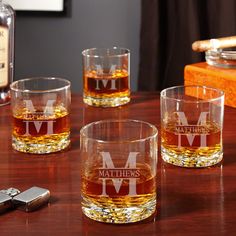 three personalized whiskey glasses on a table