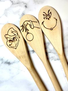 three wooden spoons with faces drawn on them