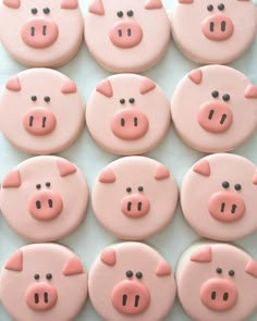 some pink and black decorated cookies with pig faces on them are arranged in the shape of pigs