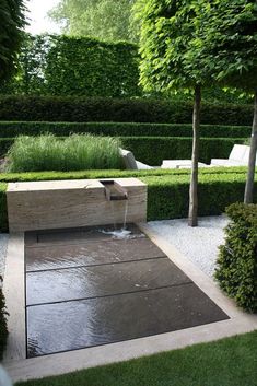 a water feature in the middle of a garden