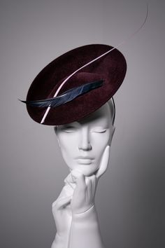 Rhia is a stunning occasion hat made from rich velour felt, modelled here in Bordeaux.  The hat is finished with a composition of feathers shown in navy and pink. This occasion hat is ideal for those special occasions, such as garden parties, investitures or a day at the races. Each hat is made exclusively by hand once you place your order.  You can order the hat in over 50 colour combinations.   This hat is so flattering, it suits so many face shapes due to its size and angle.  Please ask if you would like advice on styling before purchasing. Hat Details: * Secures with millinery headband and comb. * The hat is made to order. * The hat can be made in other base colours, see our velour shades. * The feathers are available in other colours, please check to confirm availability before orderi Bordeaux, Millinery Headband, Royal Garden Party, Hat With Feather, Day At The Races, Occasion Hats, Metal Comb, Shoe Brushes, Hat Custom