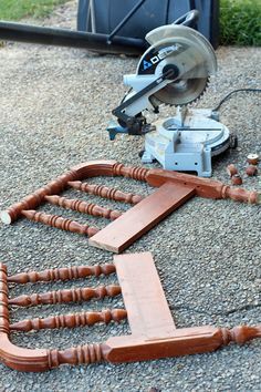 a circular sawhorse is laying on the ground next to some wood planks and other tools