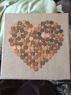 a heart made out of coins on a canvas