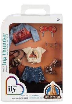 the doll is in its box with clothes and accessories on it's display stand