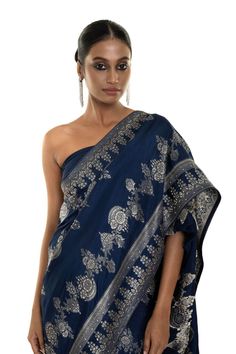 Elevate your style with our Blue Floral Printed Art Silk handwoven saree featuring allover stone embroidery work. This saree exudes elegance, ideal for family gatherings or formal events. Experience timeless beauty that will be a wardrobe treasure for years to come. Festive Pre-draped Saree With Motifs For Reception, Eid Reception Zari Weaving Pre-draped Saree, Eid Reception Blouse Piece With Zari Weaving, Eid Blouse Piece With Zari Weaving For Reception, Eid Blouse Piece For Reception With Zari Weaving, Banarasi Silk Pre-draped Saree For Eid Reception, Elegant Pre-draped Saree With Motifs For Navratri, Banarasi Silk Pre-draped Saree With Zari Weaving For Reception, Reception Tussar Silk Saree With Pallu Detail