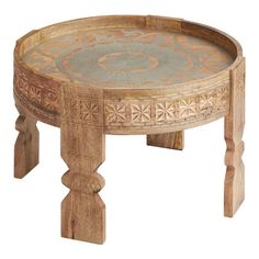 a wooden table with an intricate design on the top