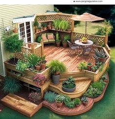 an outdoor deck with potted plants and patio furniture