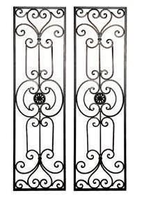 two black iron doors with decorative designs on them